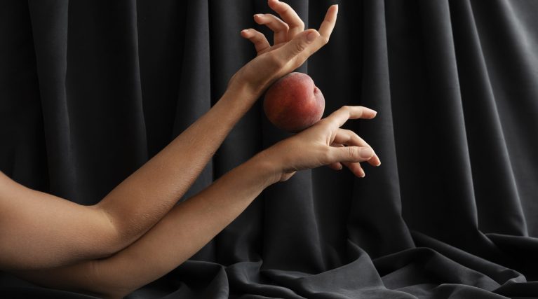 side-view-arms-posing-with-peach side-view-arms-posing-with-peach