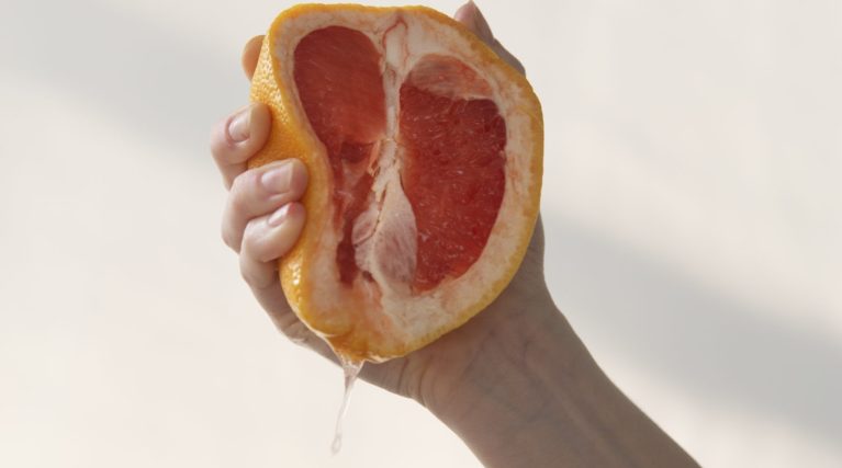 hand-holding-grapefruit-summertime hand-holding-grapefruit-summertime