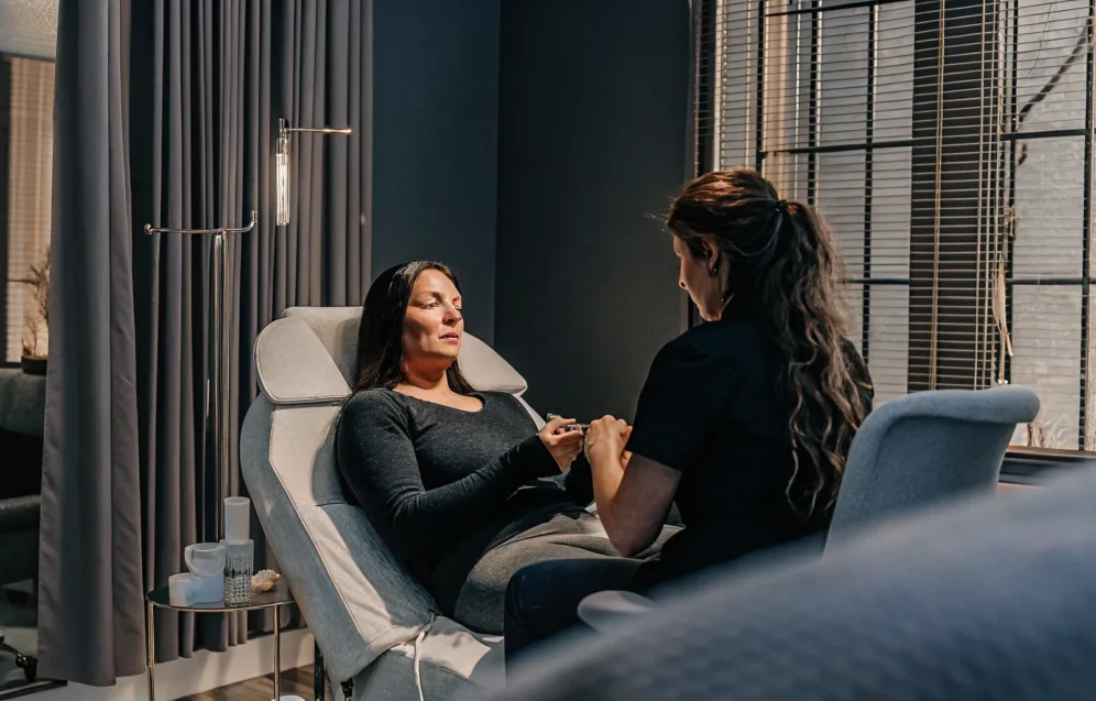 lip-filler-tampa-natural-looking-consultation-guide Patient discussing natural-looking lip filler goals with a clinical provider in Tampa