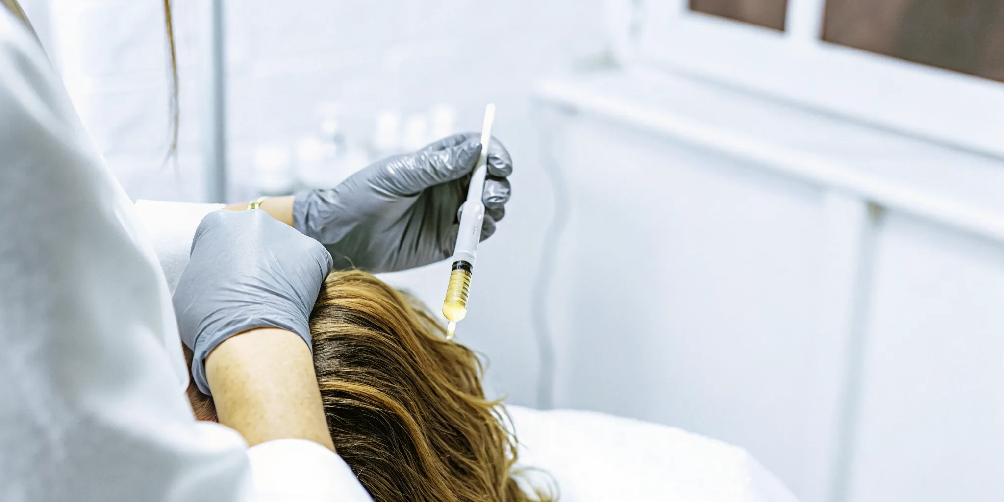 Board-certified physician performing a PRP scalp injection procedure at a Tampa medical clinic under sterile conditions